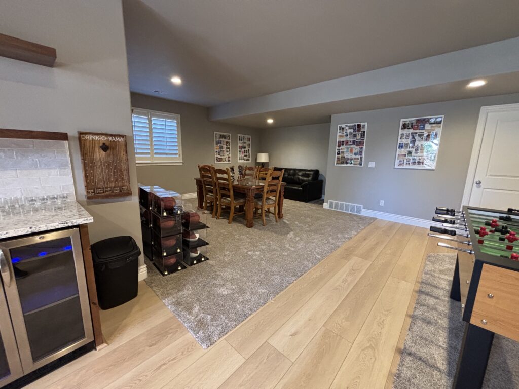 Finished basement family room with wine fridge and dining area in Davis County, Utah